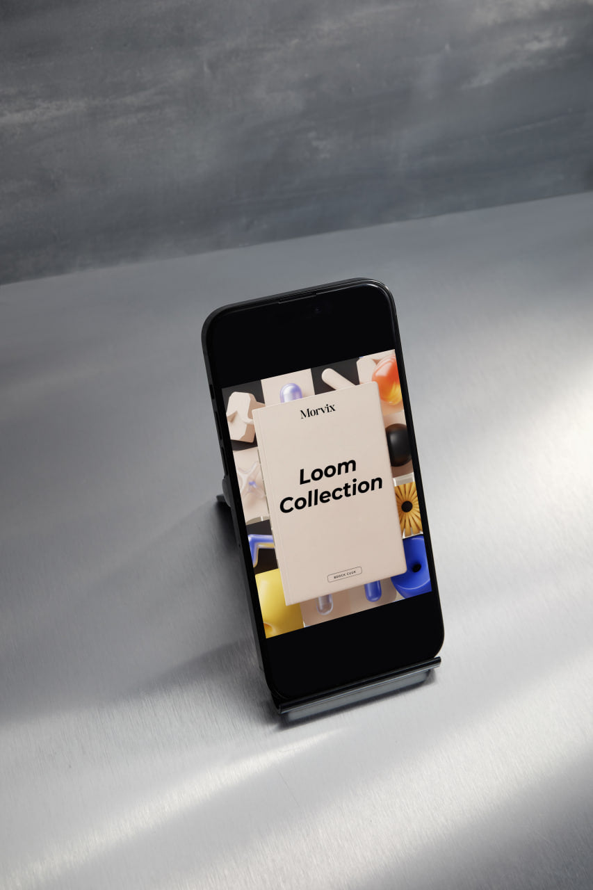 Phone displaying a 'Loom Collection' app on a gray surface